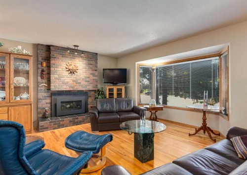 4808 Valiant Drive Nw, Calgary, AB - Indoor Photo Showing Living Room With Fireplace