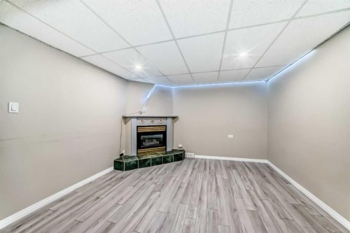 4607 Marwood Way Ne, Calgary, AB - Indoor Photo Showing Other Room With Fireplace