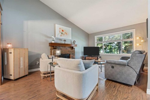 49 Lock Crescent, Okotoks, AB - Indoor Photo Showing Living Room With Fireplace
