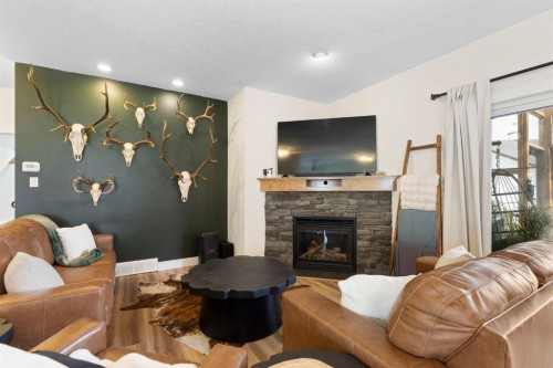128 Hillcrest Cape, Strathmore, AB - Indoor Photo Showing Living Room With Fireplace