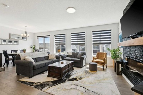160 Precedence Hill, Cochrane, AB - Indoor Photo Showing Living Room With Fireplace