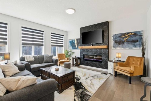 160 Precedence Hill, Cochrane, AB - Indoor Photo Showing Living Room With Fireplace
