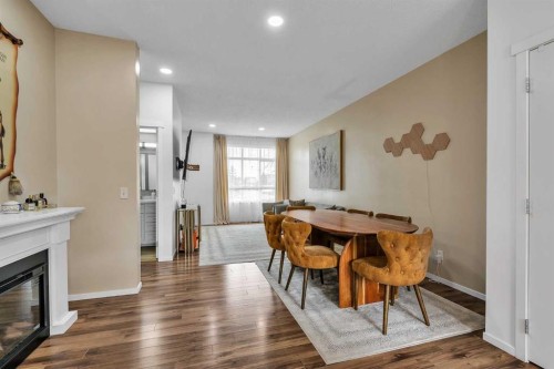 300 Copperstone Cove Se, Calgary, AB - Indoor Photo Showing Dining Room With Fireplace
