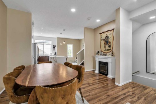 300 Copperstone Cove Se, Calgary, AB - Indoor Photo Showing Dining Room With Fireplace