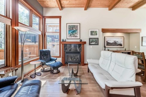 B-272 Three Sisters Drive, Canmore, AB - Indoor Photo Showing Living Room With Fireplace