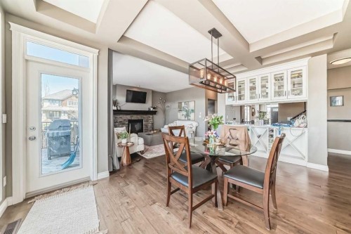 7 Westland Manor Sw, Calgary, AB - Indoor Photo Showing Dining Room With Fireplace