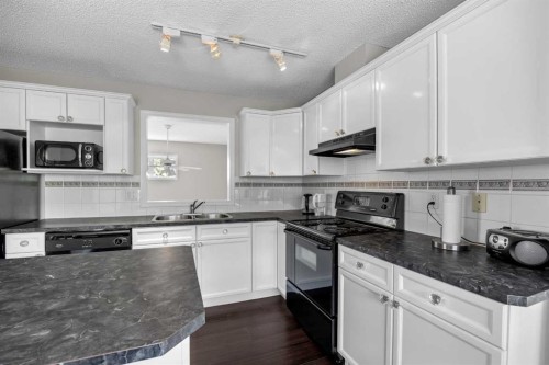 33 Country Hills Cove Nw, Calgary, AB - Indoor Photo Showing Kitchen With Double Sink