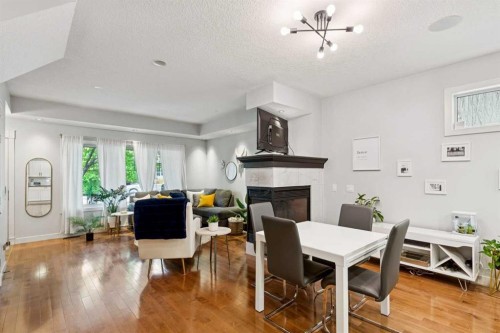 1-528 34 Street Nw, Calgary, AB - Indoor Photo Showing Dining Room With Fireplace