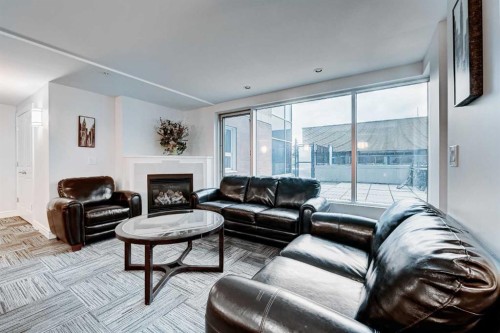 2308-920 5 Avenue Sw, Calgary, AB - Indoor Photo Showing Living Room With Fireplace