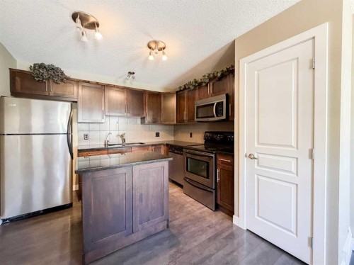 117 Panatella Hill Nw, Calgary, AB - Indoor Photo Showing Kitchen With Double Sink