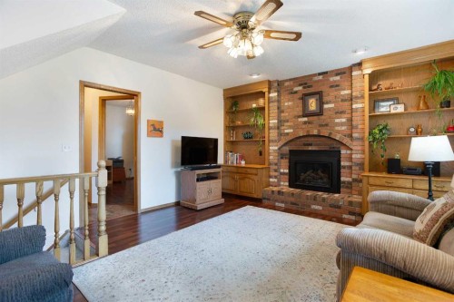 26 Sunhaven Link Se, Calgary, AB - Indoor Photo Showing Living Room With Fireplace