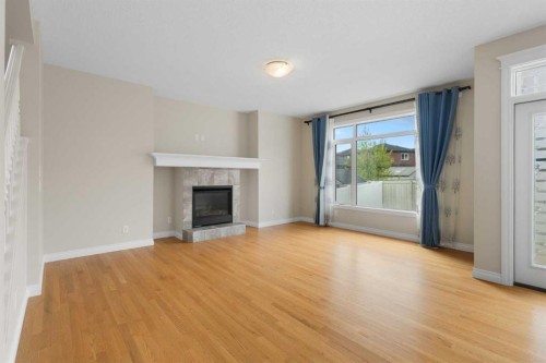 486 Silverado Boulevard Sw, Calgary, AB - Indoor Photo Showing Living Room With Fireplace