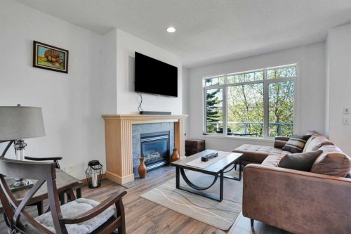 6 Discovery Woods Villas Sw, Calgary, AB - Indoor Photo Showing Living Room With Fireplace