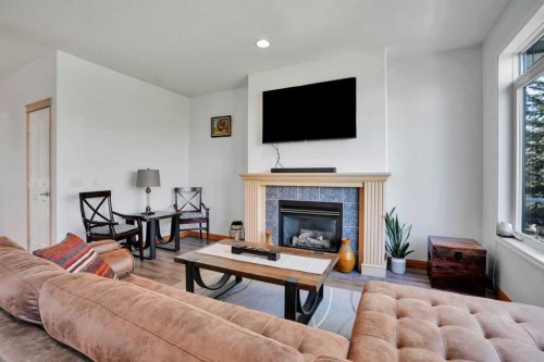6 Discovery Woods Villas Sw, Calgary, AB - Indoor Photo Showing Living Room With Fireplace