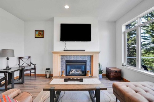 6 Discovery Woods Villas Sw, Calgary, AB - Indoor Photo Showing Living Room With Fireplace
