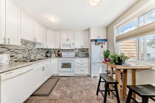 48 Millcrest Way Sw, Calgary, AB - Indoor Photo Showing Kitchen With Double Sink
