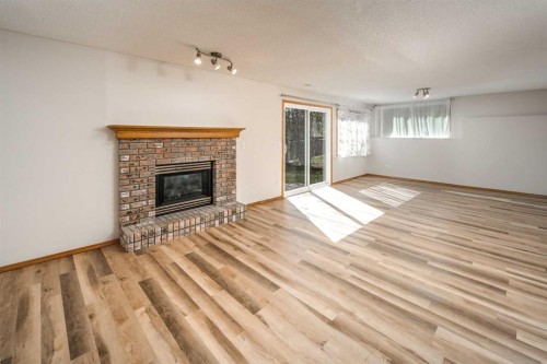 149 Sceptre Court Nw, Calgary, AB - Indoor Photo Showing Living Room With Fireplace