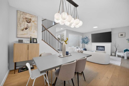 267 Bluerock Avenue Sw, Calgary, AB - Indoor Photo Showing Dining Room With Fireplace