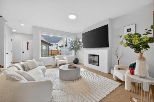 267 Bluerock Avenue Sw, Calgary, AB - Indoor Photo Showing Living Room With Fireplace