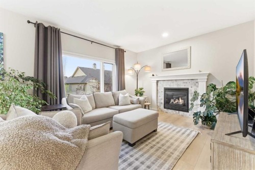 74 Evercreek Bluffs Road Sw, Calgary, AB - Indoor Photo Showing Living Room With Fireplace