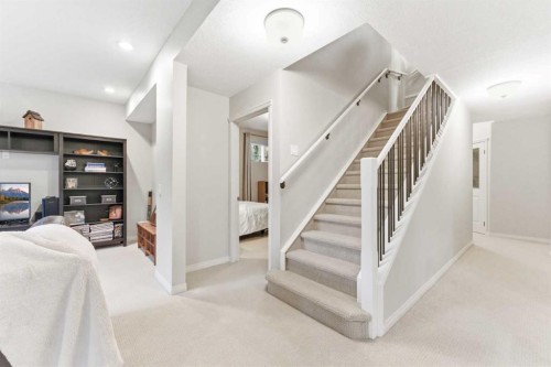 74 Evercreek Bluffs Road Sw, Calgary, AB - Indoor Photo Showing Other Room With Fireplace