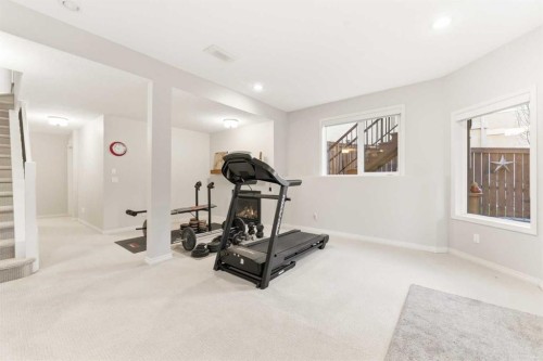 74 Evercreek Bluffs Road Sw, Calgary, AB - Indoor Photo Showing Gym Room