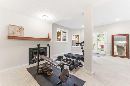 74 Evercreek Bluffs Road Sw, Calgary, AB - Indoor Photo Showing Other Room With Fireplace