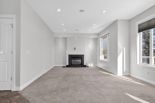 14 Discovery Woods Villas Sw, Calgary, AB - Indoor With Fireplace