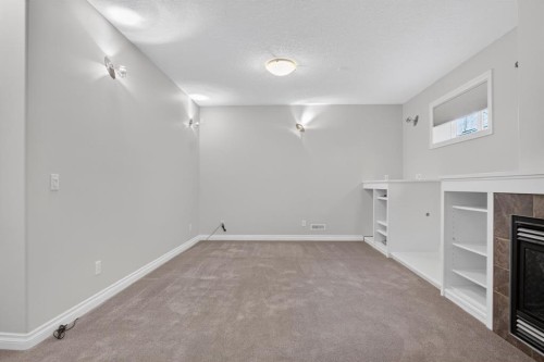 14 Discovery Woods Villas Sw, Calgary, AB - Indoor Photo Showing Other Room With Fireplace