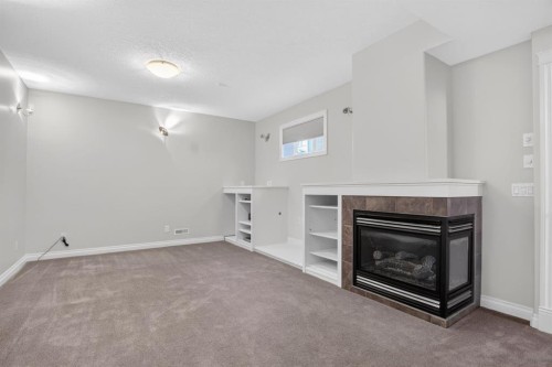 14 Discovery Woods Villas Sw, Calgary, AB - Indoor With Fireplace