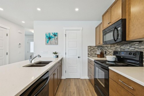 231 Kingsbridge Road Se, Airdrie, AB - Indoor Photo Showing Kitchen With Double Sink With Upgraded Kitchen