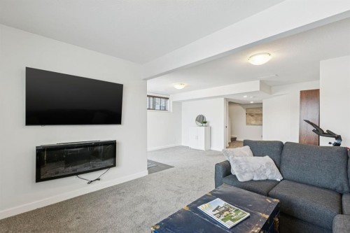 231 Kingsbridge Road Se, Airdrie, AB - Indoor Photo Showing Living Room With Fireplace