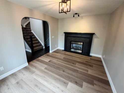 32 Carriere Crescent, Beaumont, AB - Indoor Photo Showing Living Room With Fireplace