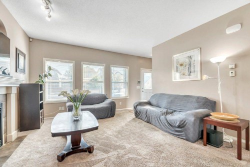 319 Saddlebrook Circle Ne, Calgary, AB - Indoor Photo Showing Living Room With Fireplace