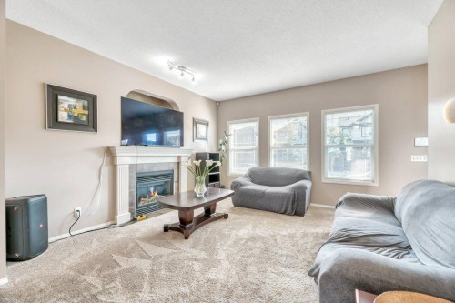 319 Saddlebrook Circle Ne, Calgary, AB - Indoor Photo Showing Living Room With Fireplace