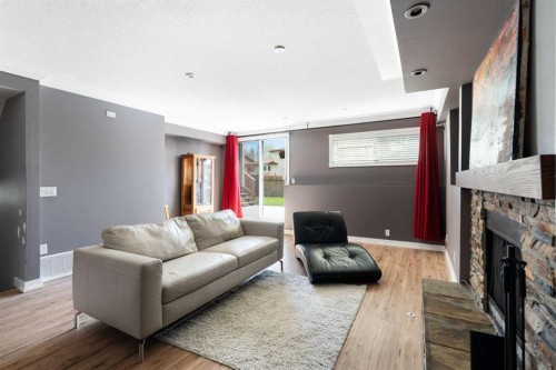 8 Hawkwood Place Nw, Calgary, AB - Indoor Photo Showing Living Room With Fireplace