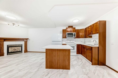 12634 Coventry Hills Way Ne, Calgary, AB - Indoor Photo Showing Kitchen With Fireplace