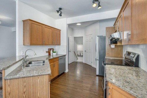 128 Sunterra Heights, Cochrane, AB - Indoor Photo Showing Kitchen With Double Sink