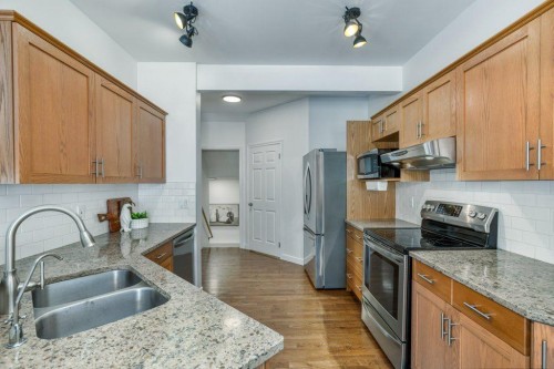 128 Sunterra Heights, Cochrane, AB - Indoor Photo Showing Kitchen With Double Sink