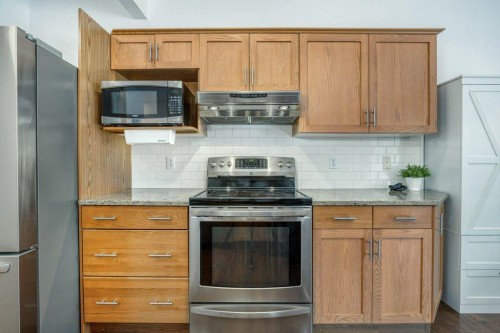 128 Sunterra Heights, Cochrane, AB - Indoor Photo Showing Kitchen
