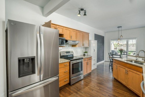 128 Sunterra Heights, Cochrane, AB - Indoor Photo Showing Kitchen With Double Sink