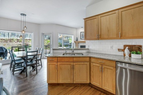 128 Sunterra Heights, Cochrane, AB - Indoor Photo Showing Kitchen With Double Sink