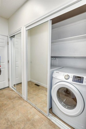 128 Sunterra Heights, Cochrane, AB - Indoor Photo Showing Laundry Room