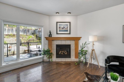 128 Sunterra Heights, Cochrane, AB - Indoor Photo Showing Living Room With Fireplace