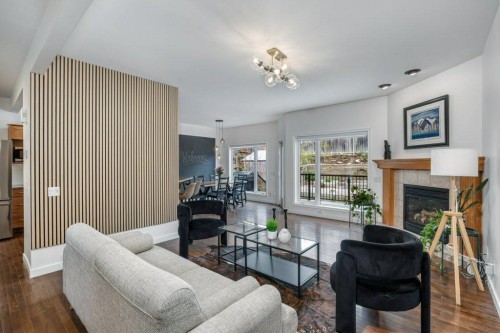 128 Sunterra Heights, Cochrane, AB - Indoor Photo Showing Living Room With Fireplace