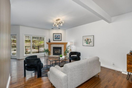 128 Sunterra Heights, Cochrane, AB - Indoor Photo Showing Living Room With Fireplace