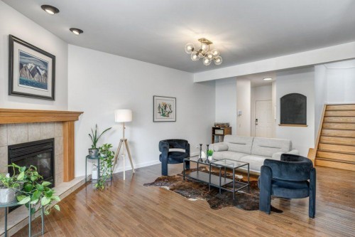 128 Sunterra Heights, Cochrane, AB - Indoor Photo Showing Living Room With Fireplace
