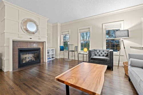 230 Garrison Square Sw, Calgary, AB - Indoor Photo Showing Living Room With Fireplace