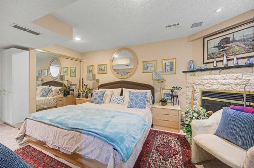 2020 Sirocco Drive Sw, Calgary, AB - Indoor Photo Showing Bedroom With Fireplace