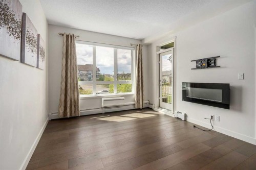 3210-175 Silverado Boulevard Sw, Calgary, AB - Indoor Photo Showing Living Room With Fireplace